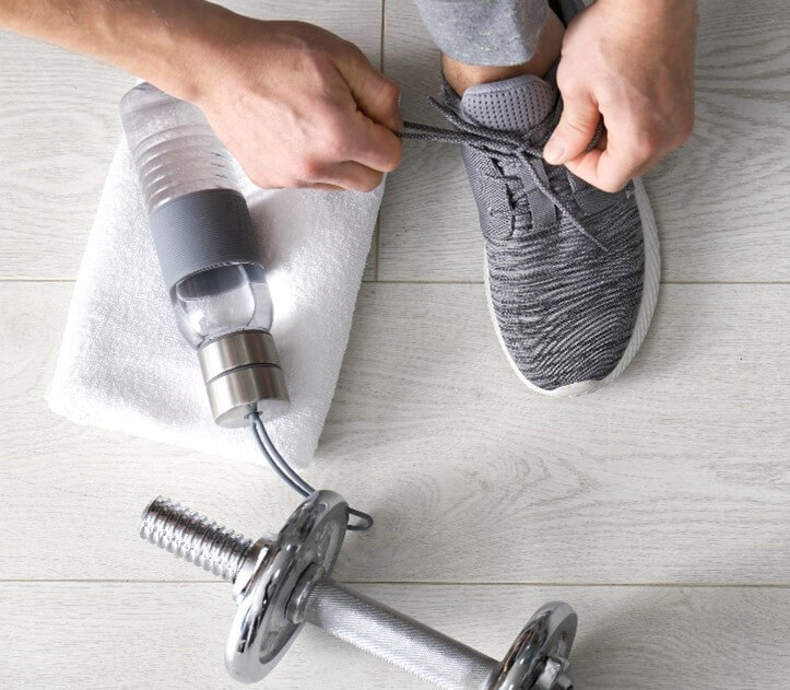 Man tying his shoes about to start exercising